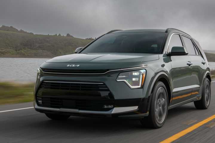 Kia Niro hybrid driving on a road. 