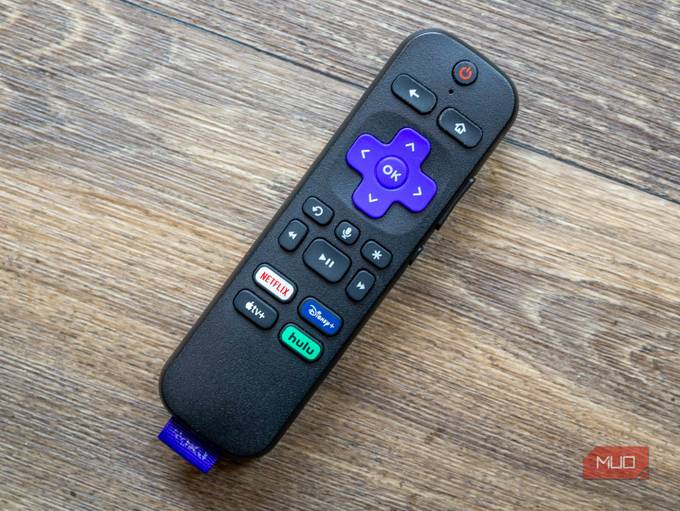 A Roku remote on a wooden table