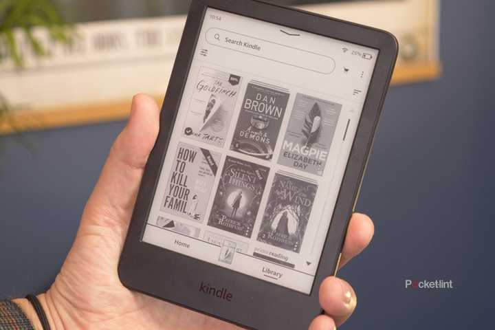 A person holding an Amazon Kindle