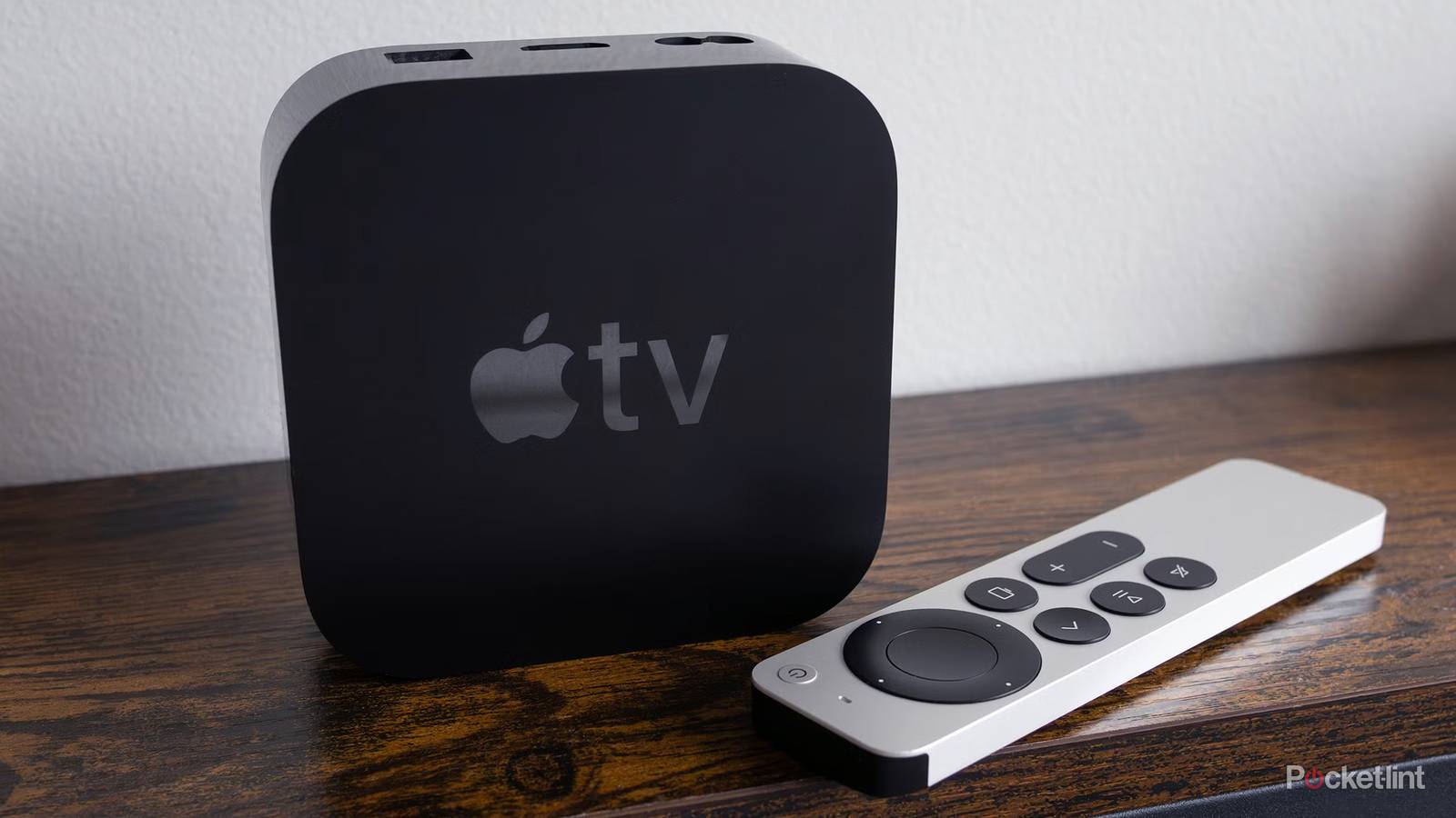 Apple TV 4K and remote on table.