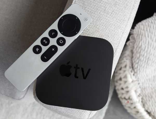 The Apple TV 4K and the Siri Remote sitting on a couch arm