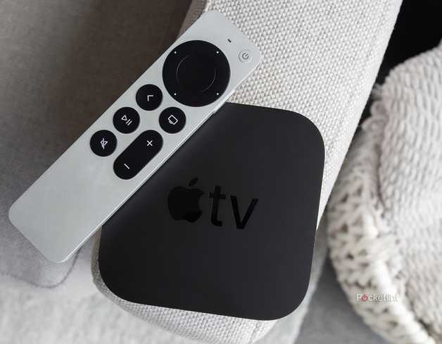 The Apple TV 4K and the Siri Remote sitting on a couch arm