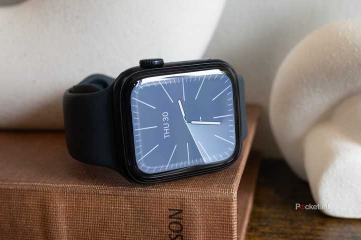 The Apple Watch SE 3 sitting on a book