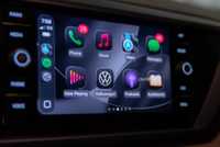 A still photo of Apple CarPlay iOS 26 with apps in dark mode. 