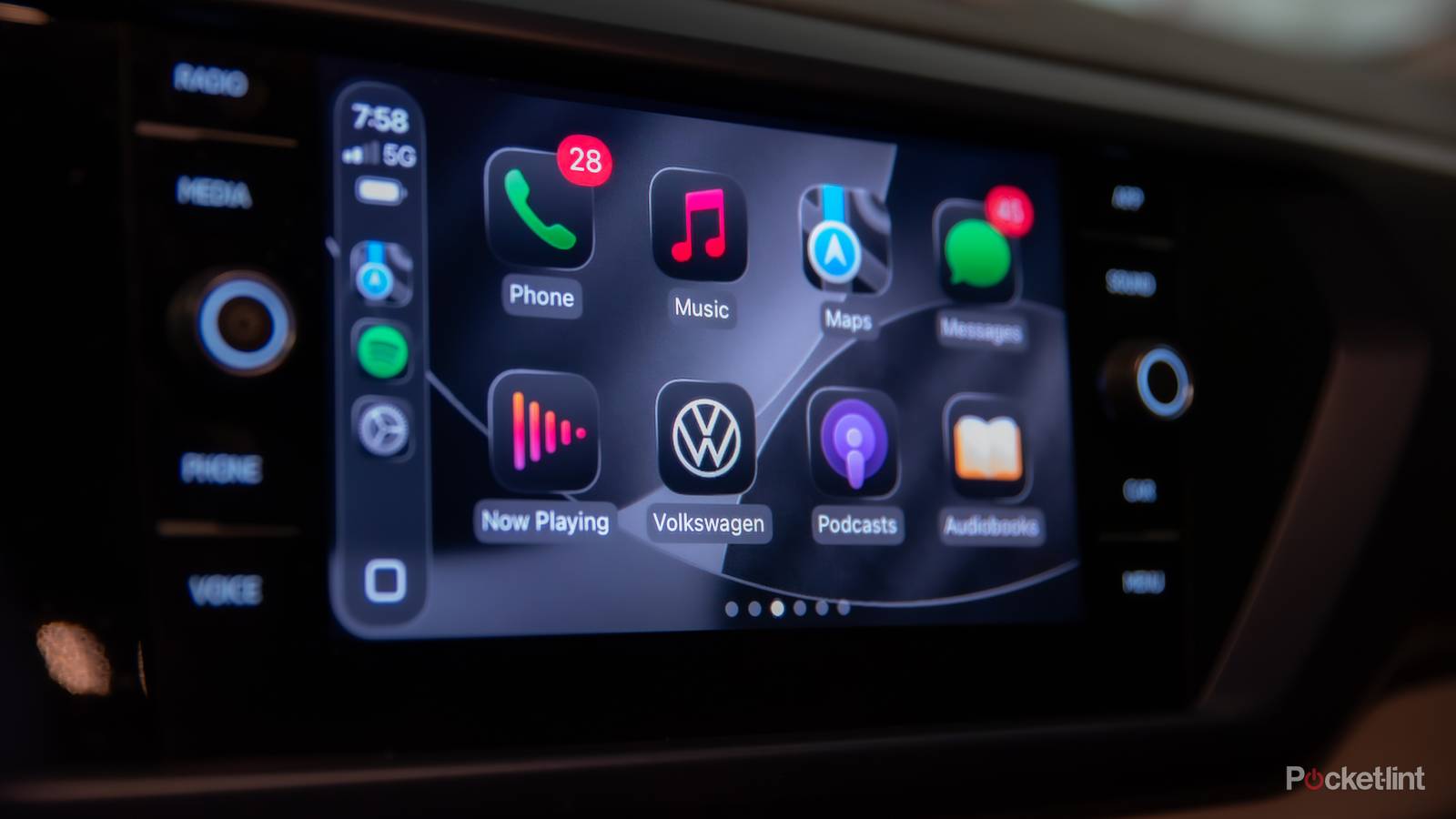 A still photo of Apple CarPlay iOS 26 with apps in dark mode. 