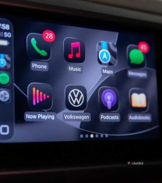 A still photo of Apple CarPlay iOS 26 with apps in dark mode. 
