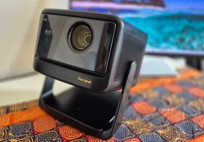 Dangbei DBOX02 Pro Projector on a table. 