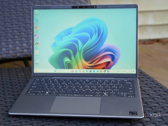 The Dell Inspiron 14 laptop on a lounge chair.