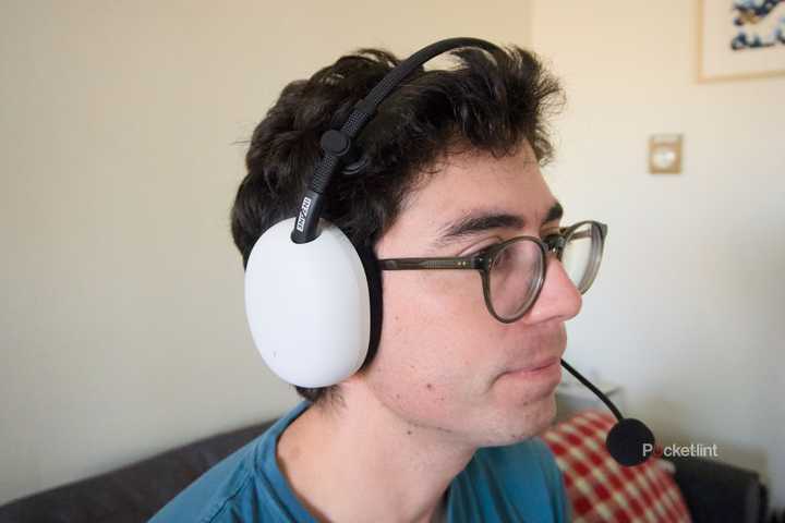 A person wearing a white InZone H9 II gaming headset.