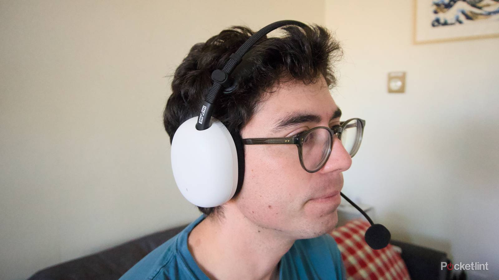 A person wearing a white InZone H9 II gaming headset.