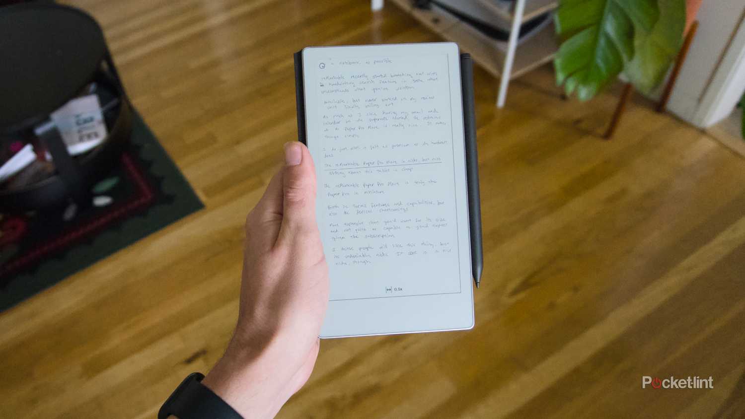 A hand holding a reMarkable Paper Pro Move