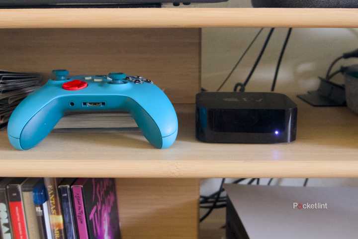 An Xbox game controller next to an Apple TV 4K.