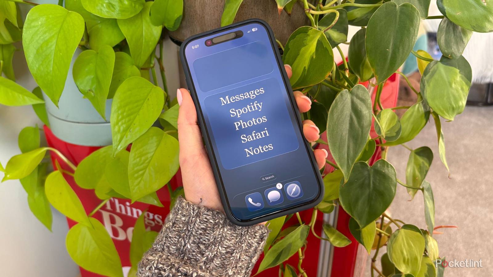 Kelsey holding a dumb iPhone. 