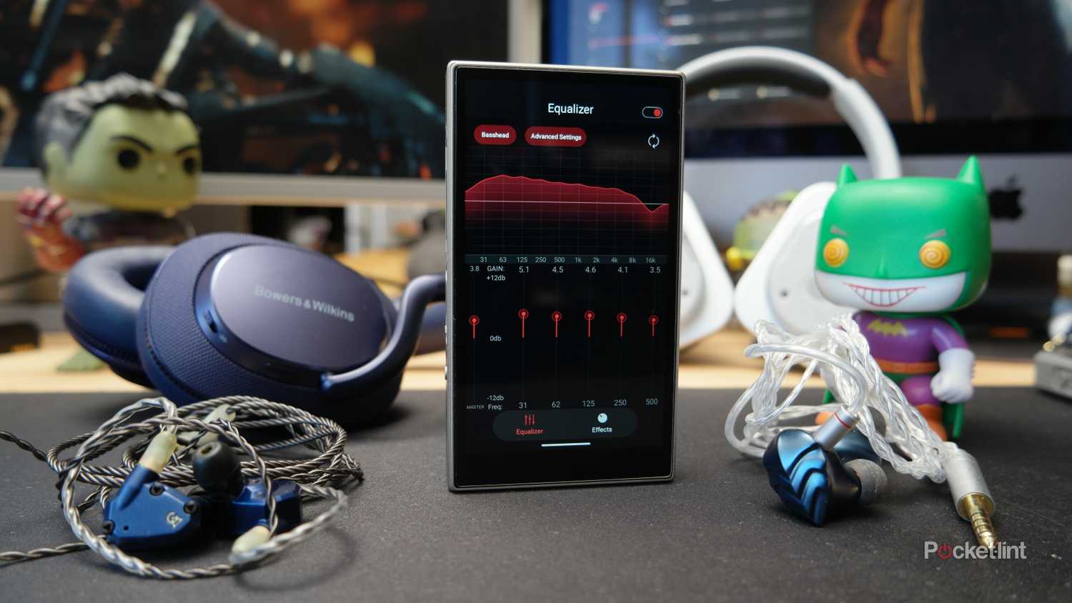 FiiO M21 showing the PEQ controls, with various headphones and IEMs around it