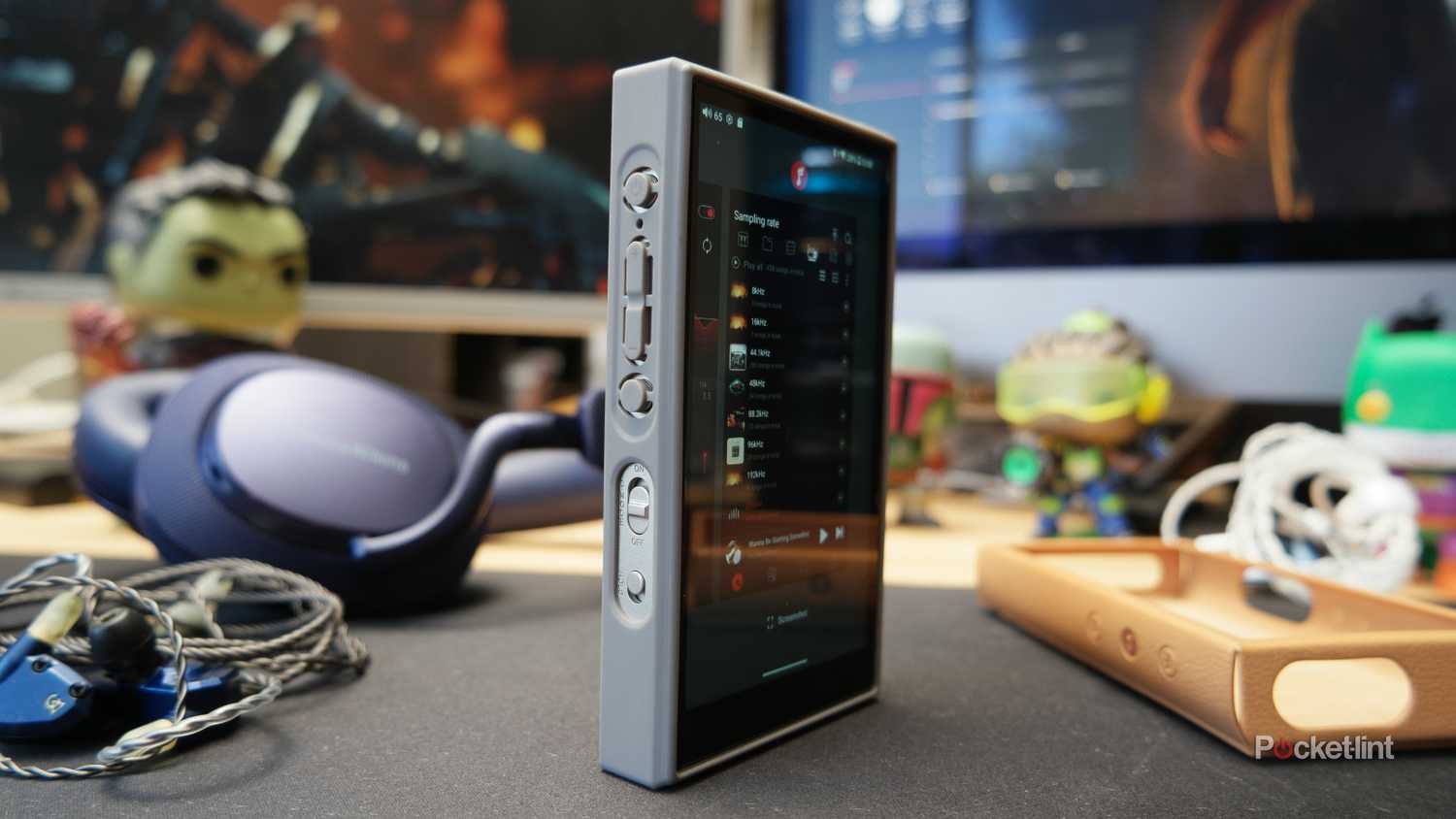 FiiO M21 shown in the included silicone case, with the optional PU case next to it