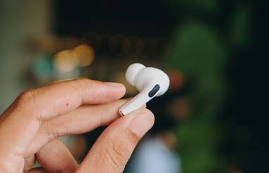 Fingers Holding One AirPod Earbud