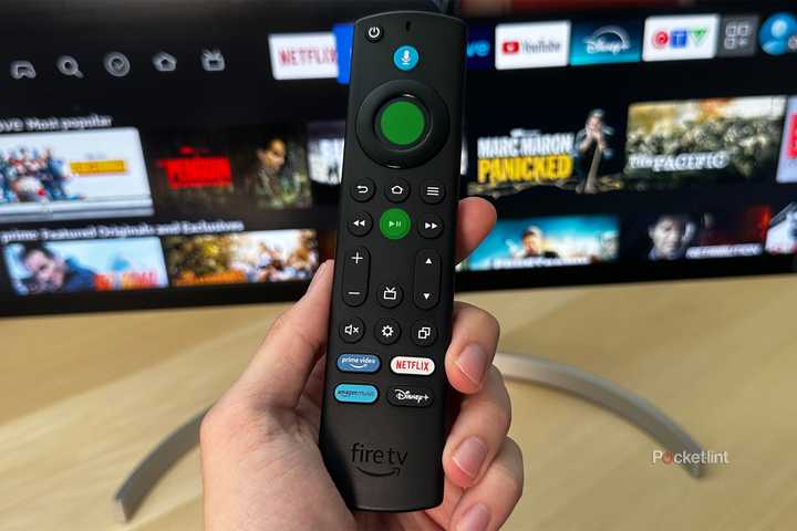 Amazon Fire TV Stick in hand with restart buttons highlighted.