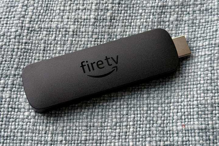 Fire TV Stick on blue pillow.