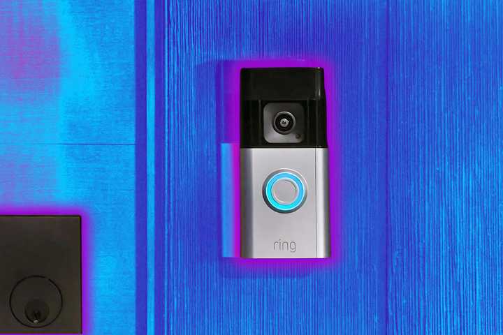 A Ring doorbell sits on doorframe