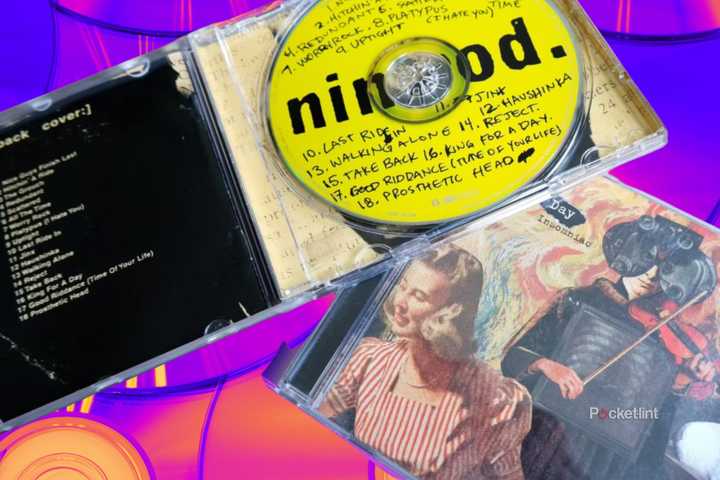 Two Green Day CD cases, one open and resting on top of the other. edit 3