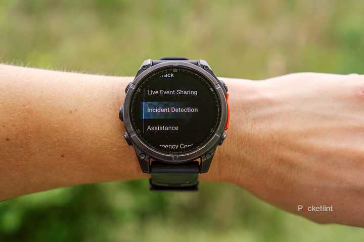 A wrist has a Garmin Fenix 8 watch on it with the Garmin Incident Detection feature on the display. 