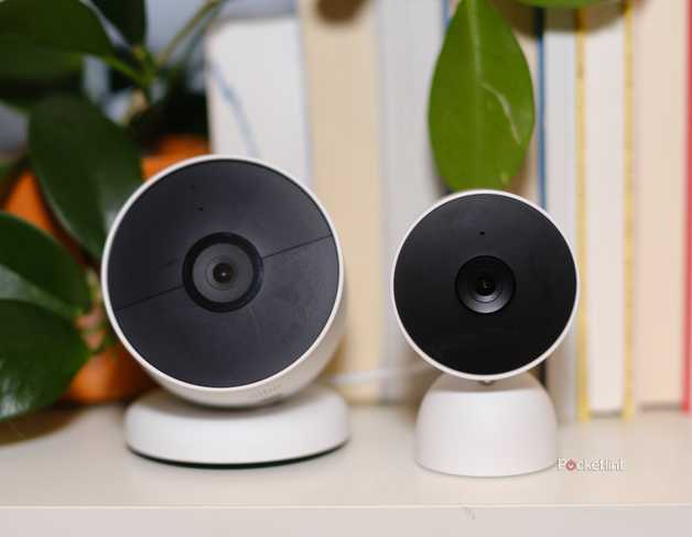 The Google Nest Cam Battery sits next to the Google Nest Cam Wired on a bookshelf