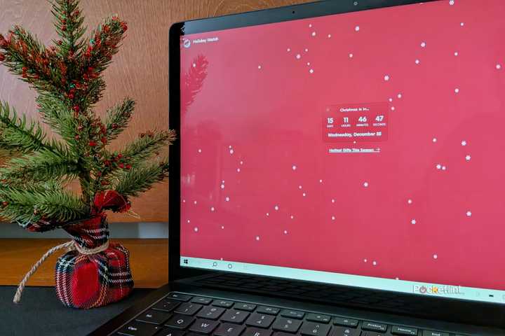 The Holiday Watch PC app running on a Surface Laptop 3.