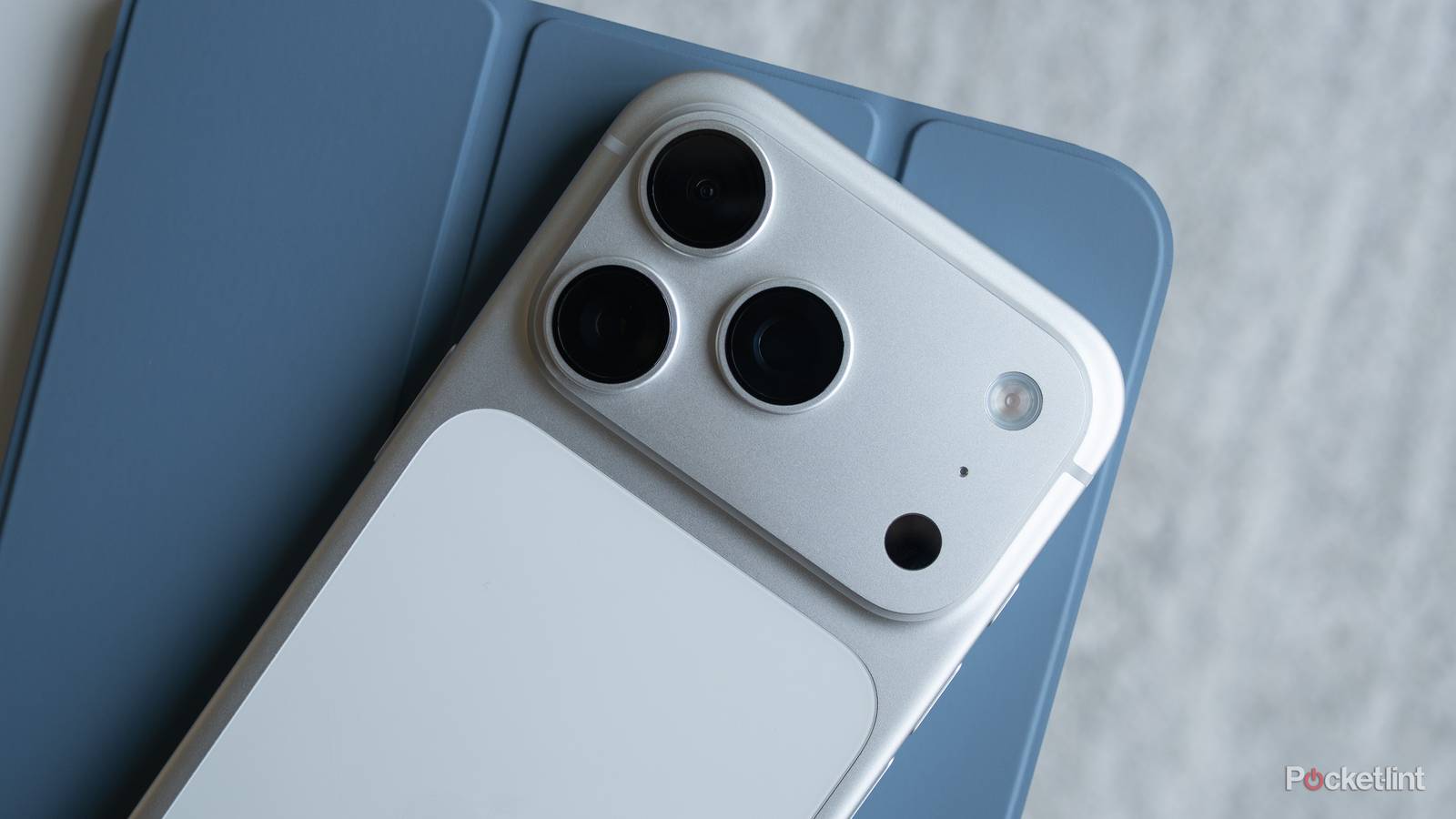 An iPhone 17 Pro sitting on top of an iPad.