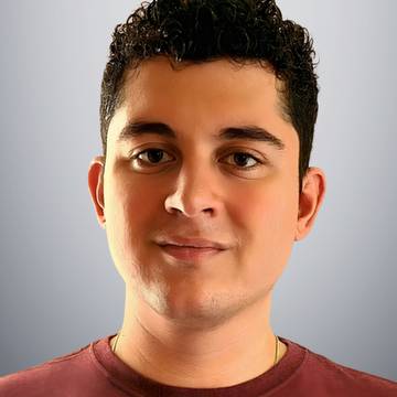 
Photo of white woman with glasses and red hair smiling at camera
