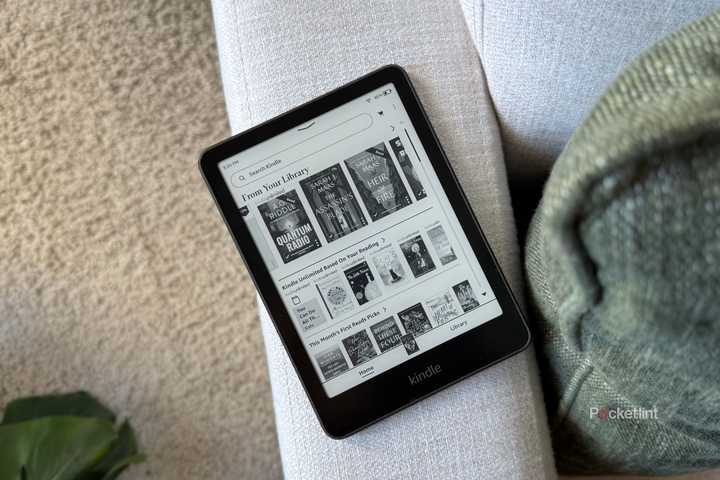 A Kindle Paperwhite on a sofa. 