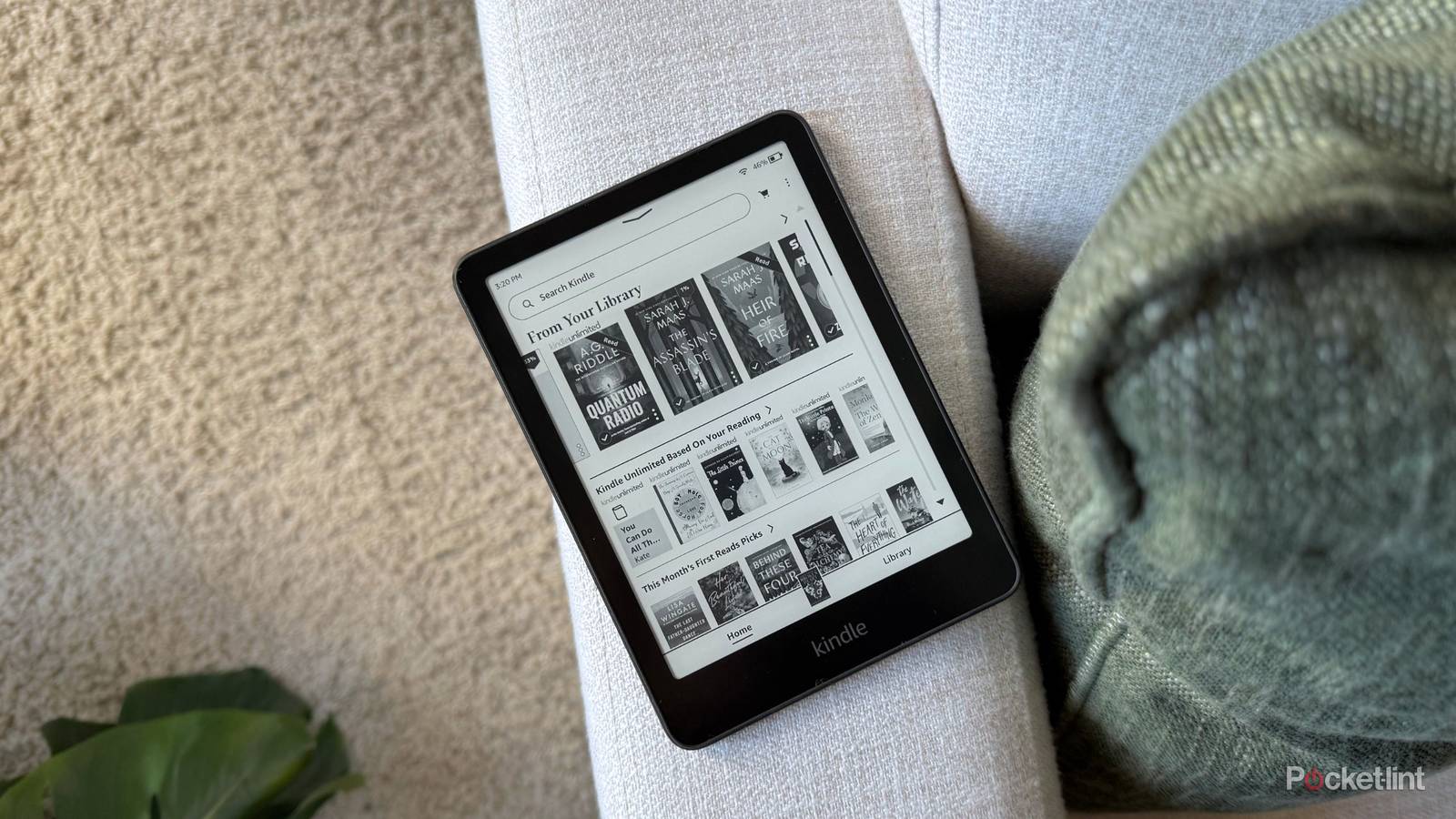 A Kindle Paperwhite on a sofa. 