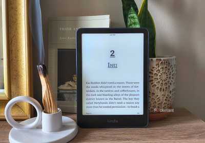 A Kindle Paperwhite in front of burning wood. 