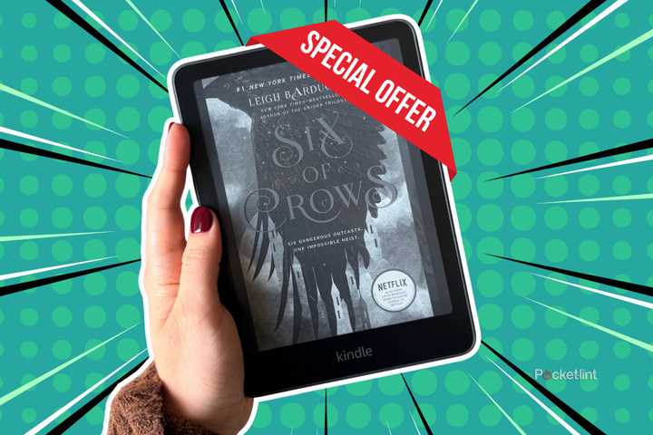 Holding a Kindle Paperwhite with a special offer. 