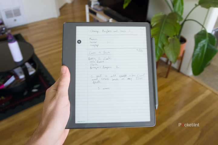 A Kindle Scribe with its stylus attached displaying handwritten notes.