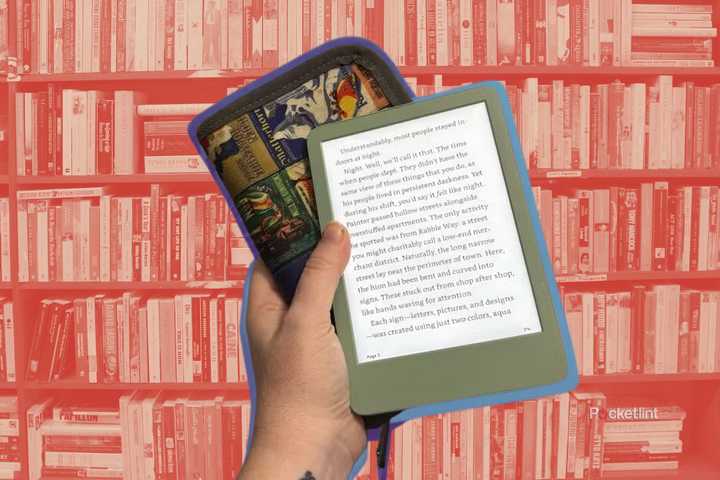 A hand holding a green Kindle and a case in front of a bookcase full of books.