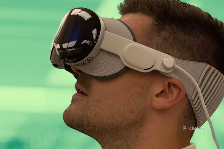 Someone wearing a Vision Pro over a green background.