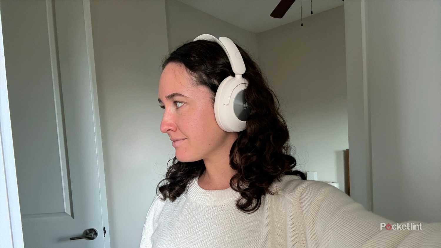 Kelsey wearing white headphones. 