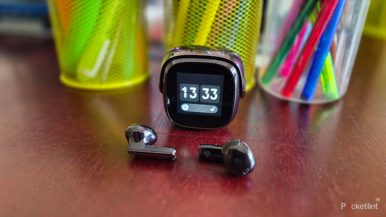 OSO AI Earbuds box and charging case on a table side