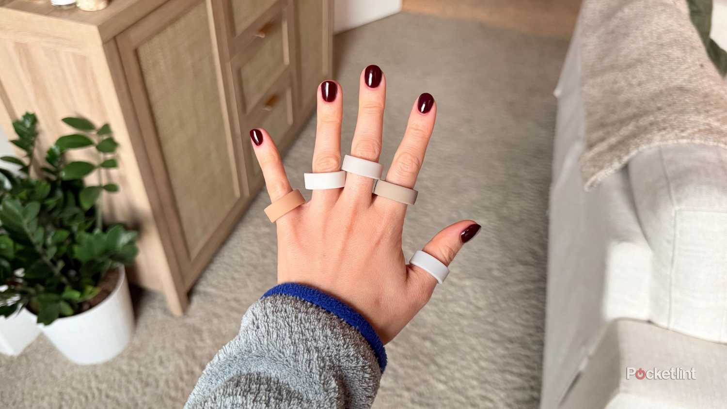 A hand with five rings on it. 