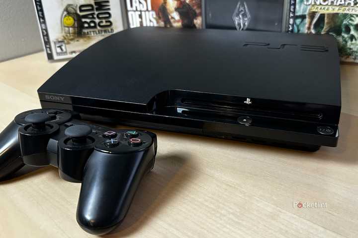PS3 on desk with games.