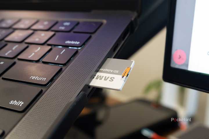 MacBook Pro SD card reader with an SD card in it 