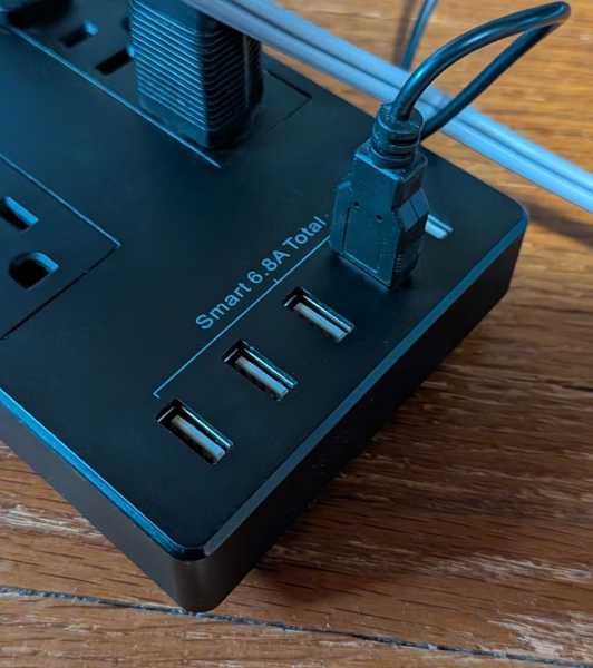 A photo of a power strip with four USB ports.