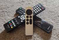 Apple TV 4K remote sitting on two remotes.