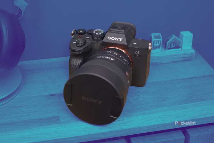 The Sony A7 IV sits on a table with the entire scene in a blue gradient. 