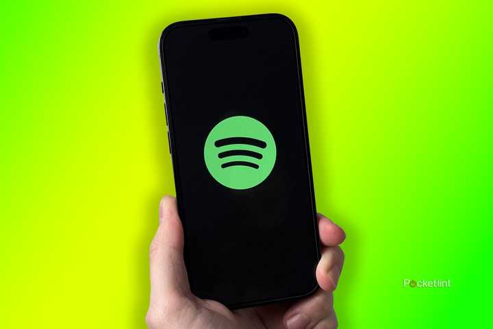 Spotify on iPhone on green background.