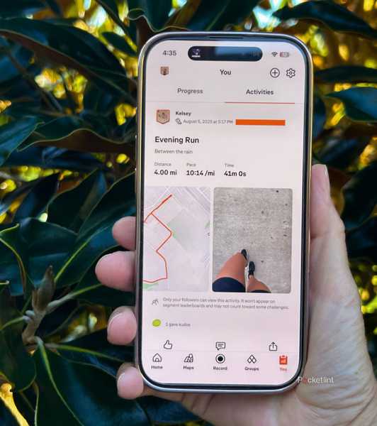 A person holding a phone with Strava on it. 