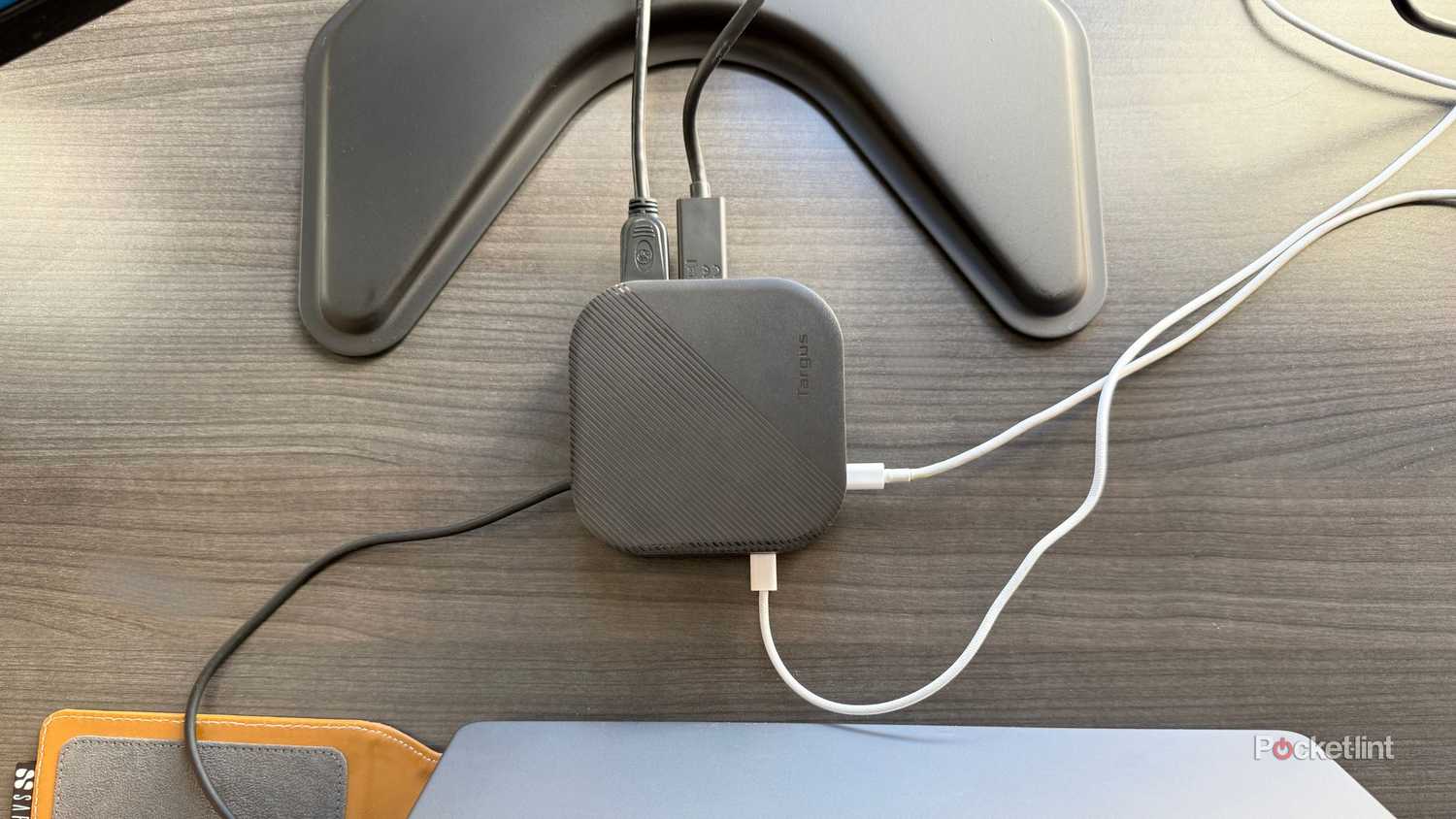 A docking station behind a computer. 