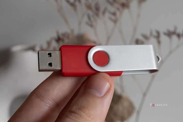 Holding a red USB stick 