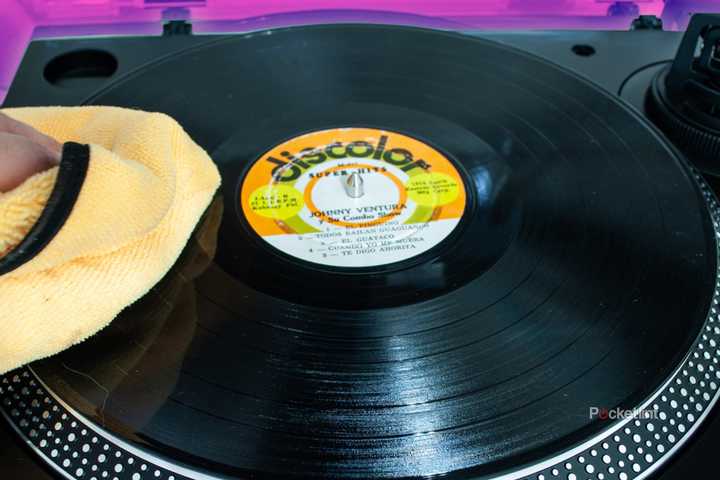 Someone wiping a vinyl with a microfiber towel. 