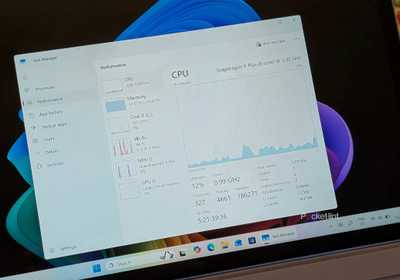 A Windows 11 PC with Task Manager running in a window.